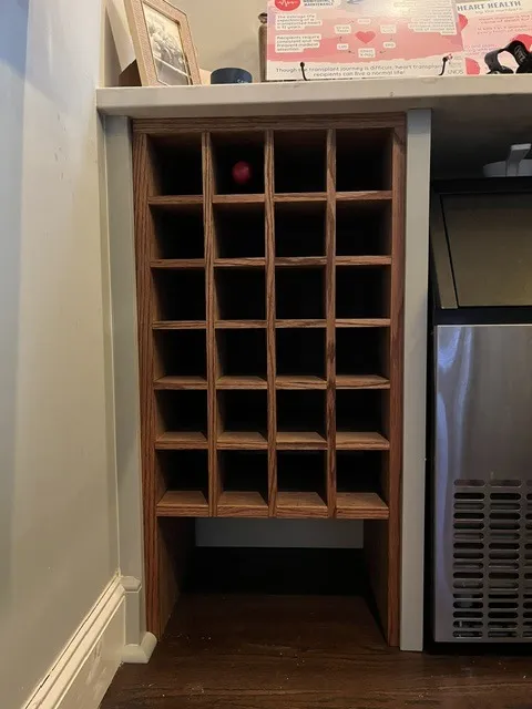 Built-in oak wine rack under a bar