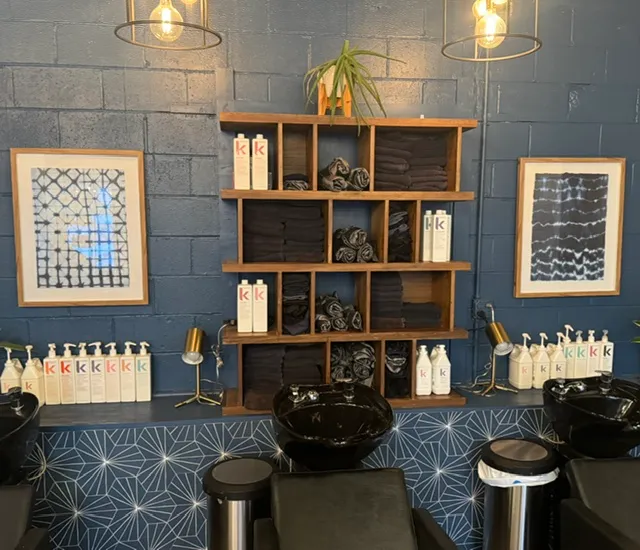 Abstract walnut shelving unit installed at a hair salon