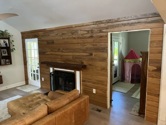 Reclaimed wood accent wall with fireplace and mantel